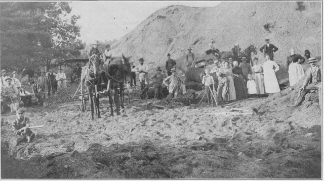 Historic black-and-white photograph of people and horse-drawn wagons hauling coal during the 1902 anthracite strike