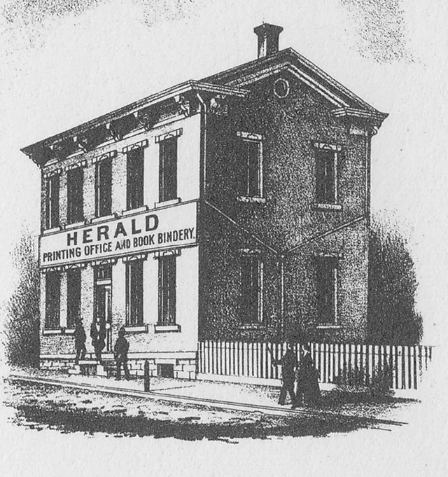 1873 illustration of the two-story Shamokin Herald printing office and book bindery with people outside