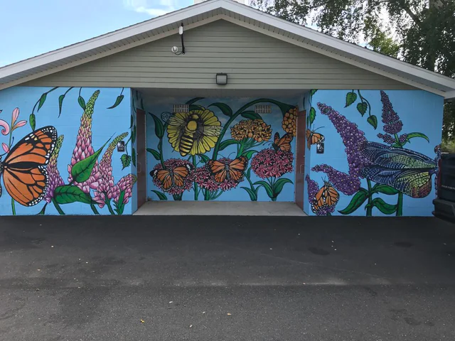 Gardens mural with painted flowers and butterfly and dragonfly wings