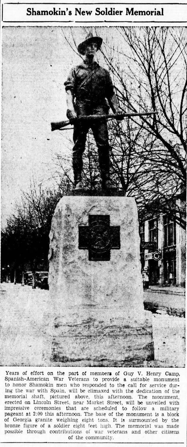 Historic newspaper photograph of a bronze soldier holding a rifle above a stone memorial base, with its original heading and dedication-announcement caption.