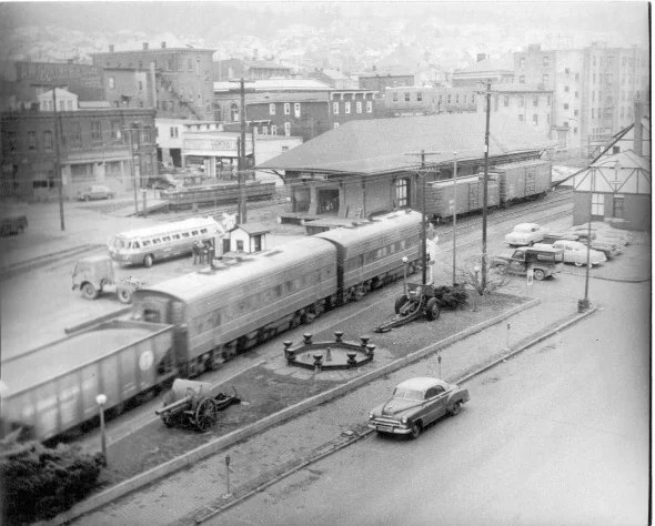 Historic Shamokin station scene with a train, depot, and bus